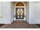 Elegant double front doors with decorative wreaths, planters, and a welcoming doormat on a brick walkway at 408 166Th E St, Bradenton, FL 34212