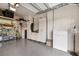 Spacious garage with a Tesla battery, storage cabinets, and shelving at 408 166Th E St, Bradenton, FL 34212