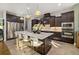 Gourmet kitchen with dark wood cabinetry, stainless appliances, and a large island at 408 166Th E St, Bradenton, FL 34212