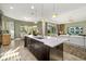 Stylish kitchen island with white countertop and seating, open to the living area at 408 166Th E St, Bradenton, FL 34212