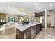 Large kitchen island with quartz countertops, stainless steel appliances, and open living space at 408 166Th E St, Bradenton, FL 34212