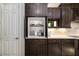 Custom coffee bar and pantry offers concealed storage and complements the modern design at 408 166Th E St, Bradenton, FL 34212