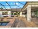 Covered lanai and pool area with a seating area and an outdoor dining table at 408 166Th E St, Bradenton, FL 34212