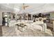 Open-concept living room with plush white sectional and views of the kitchen at 408 166Th E St, Bradenton, FL 34212