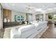 Spacious living room with modern furnishings, tray ceilings, and wood flooring at 408 166Th E St, Bradenton, FL 34212