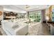 Open-concept living room with a large sofa, patio access, and modern decor at 408 166Th E St, Bradenton, FL 34212