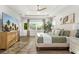 Relaxing main bedroom with a large window, tray ceiling, and a ceiling fan at 408 166Th E St, Bradenton, FL 34212