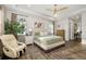 Spacious main bedroom featuring a tray ceiling, wood floors, and a relaxing massage chair at 408 166Th E St, Bradenton, FL 34212