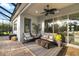 Comfortable screened-in patio area featuring plush seating, a fire pit, and serene outdoor ambiance at 408 166Th E St, Bradenton, FL 34212