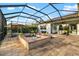 Screened pool and spa surrounded by brick-paved deck, lounge chairs, and outdoor seating area at 408 166Th E St, Bradenton, FL 34212