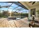 Inviting screened-in pool area with a built-in spa, patio seating, and lush tropical surroundings at 408 166Th E St, Bradenton, FL 34212