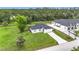 Aerial view of home features a large yard and nearby wooded area at 4148 Lobelia St, North Port, FL 34286