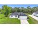 Aerial view of home features a large yard and nearby wooded area at 4148 Lobelia St, North Port, FL 34286