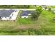Aerial view of property showcasing its large lot, backyard setup, and proximity to the neighborhood at 4148 Lobelia St, North Port, FL 34286