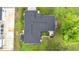 Aerial view showcasing roof, outdoor living space, and ample backyard with lush greenery and patio area at 4148 Lobelia St, North Port, FL 34286