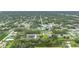 High aerial view of neighborhood surrounded by trees, homes feature spacious lots at 4148 Lobelia St, North Port, FL 34286