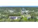 Aerial shot of neighborhood homes surrounded by lush green trees at 4148 Lobelia St, North Port, FL 34286