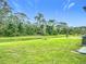 Enjoy the serene backyard with its vast green space, bordered by mature trees and natural Florida landscape at 4148 Lobelia St, North Port, FL 34286