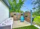 Charming backyard featuring a seating area with a sofa, chair, table, and lawn at 4148 Lobelia St, North Port, FL 34286