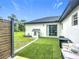 Backyard featuring a patio, grill, playhouse, and privacy fence with lush landscaping at 4148 Lobelia St, North Port, FL 34286