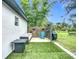Charming backyard featuring a seating area with a sofa, chair, table, and lawn at 4148 Lobelia St, North Port, FL 34286