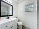 Bright bathroom with modern vanity, large mirror, and neutral walls at 4148 Lobelia St, North Port, FL 34286