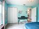 Bright bedroom featuring light blue walls, white trim, and a sleek digital piano with matching bench at 4148 Lobelia St, North Port, FL 34286