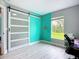 Bedroom featuring bright accent wall and sliding barn door at 4148 Lobelia St, North Port, FL 34286