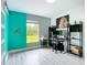 Bedroom featuring bright accent wall and view of the outdoors at 4148 Lobelia St, North Port, FL 34286
