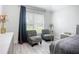 Bright bedroom with wood-look floors, sitting area, and neutral walls at 4148 Lobelia St, North Port, FL 34286