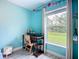 Bright bedroom with blue walls and a view of the outdoors at 4148 Lobelia St, North Port, FL 34286