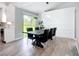 Dining area with a modern table, stylish chairs, and sliding glass doors to the yard at 4148 Lobelia St, North Port, FL 34286