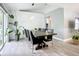 Dining room with sleek furniture, decorative wall paneling, and bright natural light at 4148 Lobelia St, North Port, FL 34286