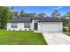 Charming single-story home features a well-manicured lawn and attached two-car garage at 4148 Lobelia St, North Port, FL 34286
