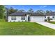 Charming single-story home features a well-manicured lawn and attached two-car garage at 4148 Lobelia St, North Port, FL 34286