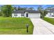 Charming single-story home features a well-manicured lawn and long driveway at 4148 Lobelia St, North Port, FL 34286
