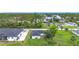 Exterior of a home featuring a spacious backyard with mature trees and partial neighborhood view at 4148 Lobelia St, North Port, FL 34286