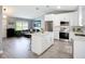 Modern kitchen featuring white cabinets, quartz countertops, stainless steel appliances, and a beautiful mosaic backsplash at 4148 Lobelia St, North Port, FL 34286