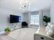 Comfortable living room featuring a white sofa, modern lighting, and a wall-mounted TV at 4148 Lobelia St, North Port, FL 34286