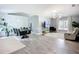Open-concept living and dining area with modern lighting and neutral color scheme at 4148 Lobelia St, North Port, FL 34286