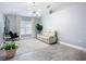 Spacious living room with a high ceiling, modern light fixture, and comfortable seating at 4148 Lobelia St, North Port, FL 34286