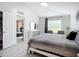 Bedroom with large window, ensuite bathroom entrance, and neutral decor at 4148 Lobelia St, North Port, FL 34286