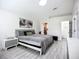 Bright main bedroom featuring wood-look floors, walk-in closet, and ensuite bathroom at 4148 Lobelia St, North Port, FL 34286