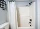 Bathroom featuring a bath tub with shower, black hardware, and a white shower curtain at 4148 Lobelia St, North Port, FL 34286