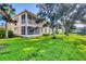 Beautiful backyard featuring lush green grass and a view of the community's exterior at 4210 Vicenza Dr # D25, Venice, FL 34293