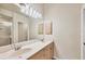 Well-lit bathroom featuring a double vanity sink, ample counter space and enclosed shower with neutral tones at 4210 Vicenza Dr # D25, Venice, FL 34293