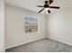 Bright bedroom with a ceiling fan, carpet, and a window providing ample natural light at 4210 Vicenza Dr # D25, Venice, FL 34293