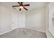 Neutral bedroom with double closet doors, a ceiling fan, and carpeted floor at 4210 Vicenza Dr # D25, Venice, FL 34293