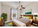 Bright bedroom with a ceiling fan, a large window, and modern decor, perfect for relaxation and rejuvenation at 4210 Vicenza Dr # D25, Venice, FL 34293
