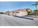 Street view of condos with attached garages featuring terracotta roofs and lush landscaping in a quiet community at 4210 Vicenza Dr # D25, Venice, FL 34293